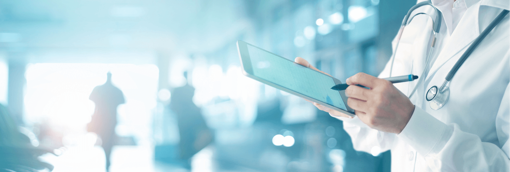 Doctor writing on iPad with blurred background